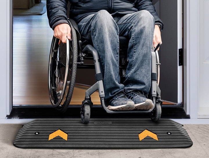 Man on wheelchair on threshold ramp